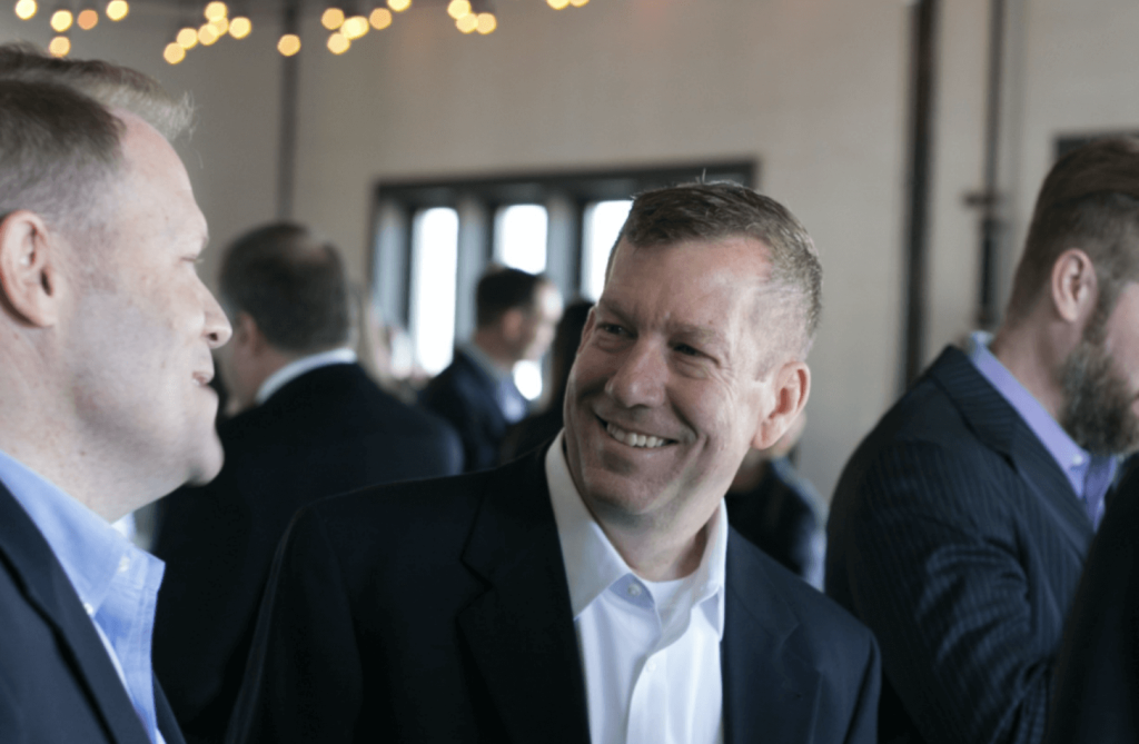 two men connecting and laughing at Tradition event