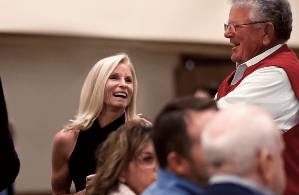 Two people talking and laughing at a Tradition event